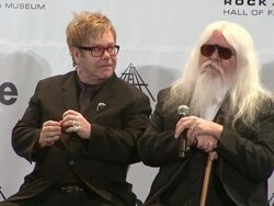 SPEECH: Elton John and Leon Russell react to being asked to remember an event in 1975.  Stock Footage