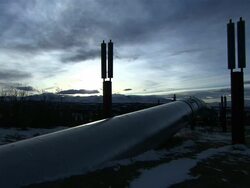 Medium Long Shot static - A section of the Alaska pipeline stretches across snowy ground. / Alaska, USA Stock Footage
