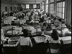 1948: FRANCE BANKING: HA WS French workers entering gates, Bank of France printing plant. INT WS Women examining new money. MS Woman looking at sheets of money. CU 5,000 France note. CU Counting 1,000 Franc notes. Currency Instructional Video