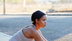 MS Smiling woman stretching on sidewalk before run with friends Stock Footage
