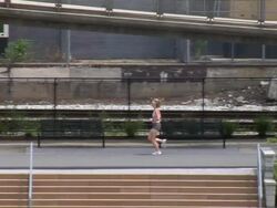 Woman running in a park Stock Footage