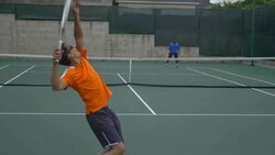 A experienced tennis player serving to a beginner tennis player. - Slow Motion Stock Footage