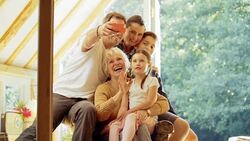 Multi-generation family taking selfie on sun porch Stock Footage