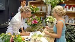 Florist helping customer in flower shop Stock Footage