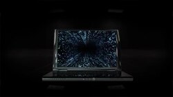 A laptop displaying a matrix becomes silhouetted against a black background. Stock Footage