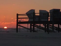 WS View of beach and roofed wicker beach chair during sunset, North Sea North Frisia, / St. Peter Ording, Schleswig Holstein, Germany Stock Footage