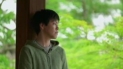 Young Japanese man holding Japanese tea at the temple. Kyoto, Japan. Stock Footage