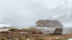 A datime winter time lapse of Smidur, a geyser in the Geysir Geothermal Field (formerly Hverasandar) in Iceland featuring steam rising from both Smidur and a man made structure in the background (on the Golden Circle tour route) Stock Footage