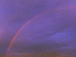 MS TD Shot of rainbow spans an interstate highway as truck and auto traffic travel east and west / Chelsea, Michigan, United States Stock Footage