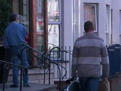 Man with guitar case walking down Belfast street, Northern Ireland Stock Footage