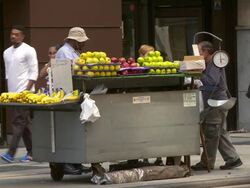 People buy fruit from a mobile food vendor in New York City. Stock Footage