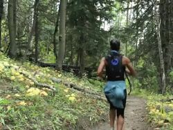 Hispanic woman running on forest path Stock Footage