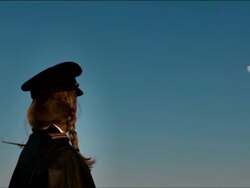 M/S female airline pilot, turns to camera, smiles as airplane passes overhead: Southwest B-737 Stock Footage