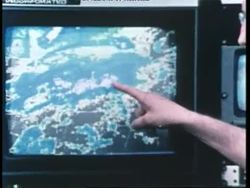 A meteorologist points to a weather map on a television screen. News Clip