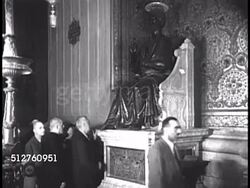 1940: VATICAN CITY: SAINT PETER'S BASILICA: Altar w/ Bernini's baldacchino & statue of Saint Peter (R). People touching, kissing foot of Saint Peter statue (cast in 5th century, foot worn from touch)   Roman Catholic, Religious Icon, Christian. Instructional Video