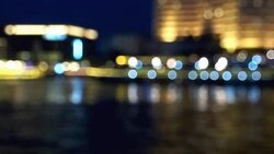 Bokeh of cityscape along river Stock Footage