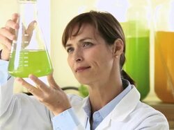 CU PAN Scientist in Biology Tech Laboratory Inspecting Liquid in Beaker / Eastville, Virginia, United States Stock Footage