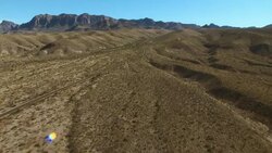 A two-lane paved road winds through Big Bend National Park leading to the High Chisos Mountains. Stock Footage