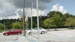 Fashion Girl Walking on Parking Lot With Cars in Background Stock Footage