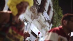 Traditional samba dancer moves to the rhythm of the drumline at outdoor concert in Rio Stock Footage