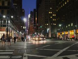 A wide shot of people and traffic at 42nd and Third early evening Stock Footage