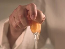 Chef's hand cracking an egg Stock Footage