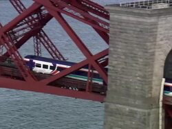 Aerial commuter train crossing Forth Bridge over Firth of Forth / Edinburgh, Scotland Stock Footage