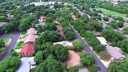AERIAL: Flying Over Local Austin Texas Housing Complex with natural Trees and Texas Hill Country feel Stock Footage
