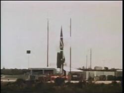 1960s tilt up missile blasting off with red smoke / Cold War / documentary Stock Footage