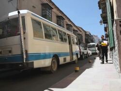 MS Shot of vehicles moving on small street with walking people / Potosi, Bolivia Stock Footage