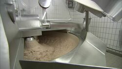 An industrial mixer churns dough. Stock Footage