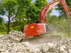 WS excavator at deconstruction of bridge over river Mosel / Wellen, Rhineland Palatinate, Germany Stock Footage