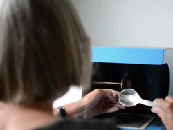 Goldsmith woman polishing silver Stock Footage
