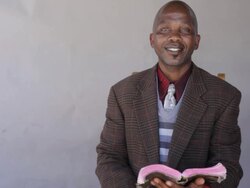 African man reading the bible with confidence Stock Footage