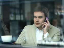 Young man drinking coffee and using phone Stock Footage
