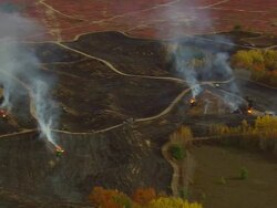 WS ARIEAL ZI ZO View of Some tractors burning blueberry fields / Maine, United States Stock Footage