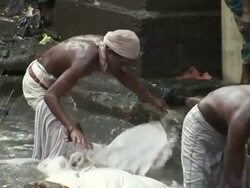 WS Group of people washing clothes in a street sewer / Dharavi, Mumbai, India Stock Footage