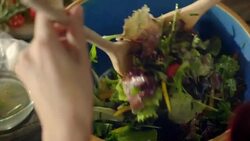 Woman preparing salad for dinner Stock Footage
