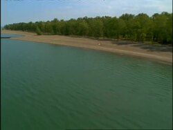 Aerial view tracking over Lake Eerie and eroding beach, USA Stock Footage