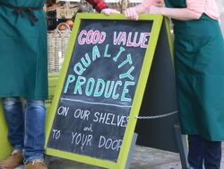 Portrait of shop owners outside grocery store Stock Footage