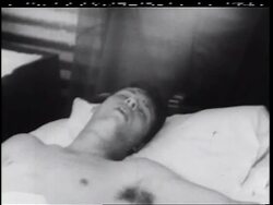 B/W 1960s close up shirtless soldier sleeping on bed in military hospital / Vietnam War / documentary Stock Footage