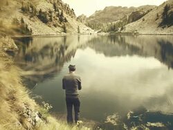 Fisherman fly fishing at lake Stock Footage