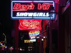 Nightlife neon outside Deja Vu on Bourbon Street in New Orleans Stock Footage