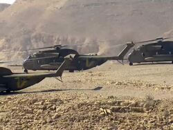 Aerial Military Helicopters on cliff in Desert, Arava, Israel Stock Footage