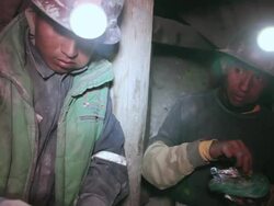 MS Shot of men eating coca leaf at mine / Potosi, Bolivia Stock Footage