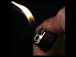 High Speed Lighter being lit, black background (2000fps, shutter speed 1/2000) Stock Footage