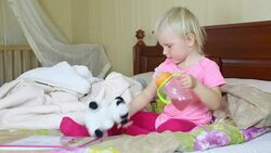 little girl playing with soft toys Stock Footage