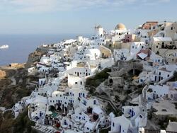 The white washed homes in the town of Oia with a view overlooking the Aegean Sea on the Island of Santorini, Greece, Europe Stock Footage