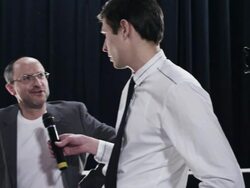 MS PAN Male fashion designer being interviewed with model backstage at fashion show being photographed by paparazzi Stock Footage