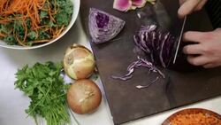 Chef chopping red cabbage for salad cutting board Stock Footage